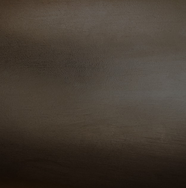 Textured surface in dark brown tones.