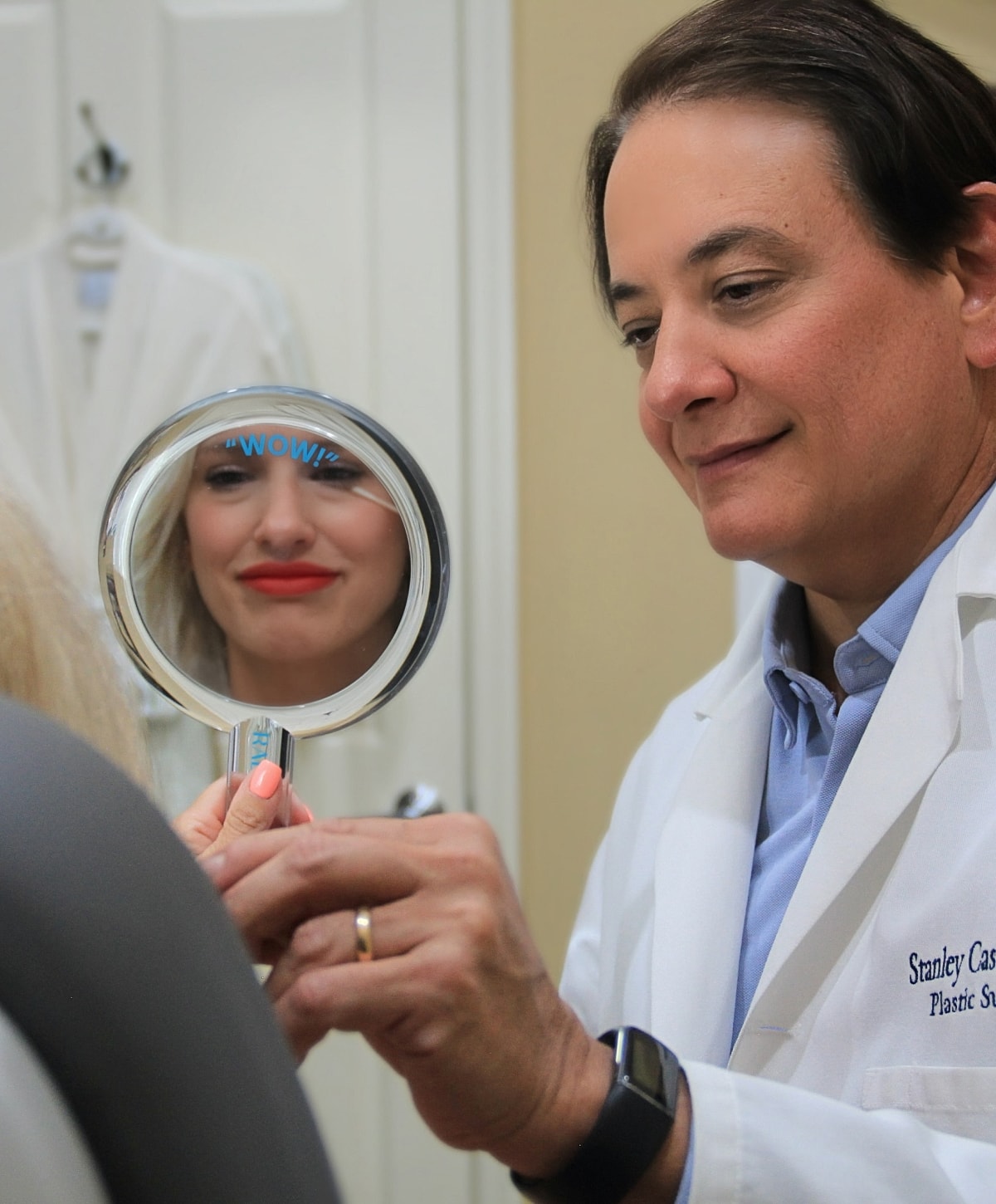 Doctor showing patient reflection in mirror.