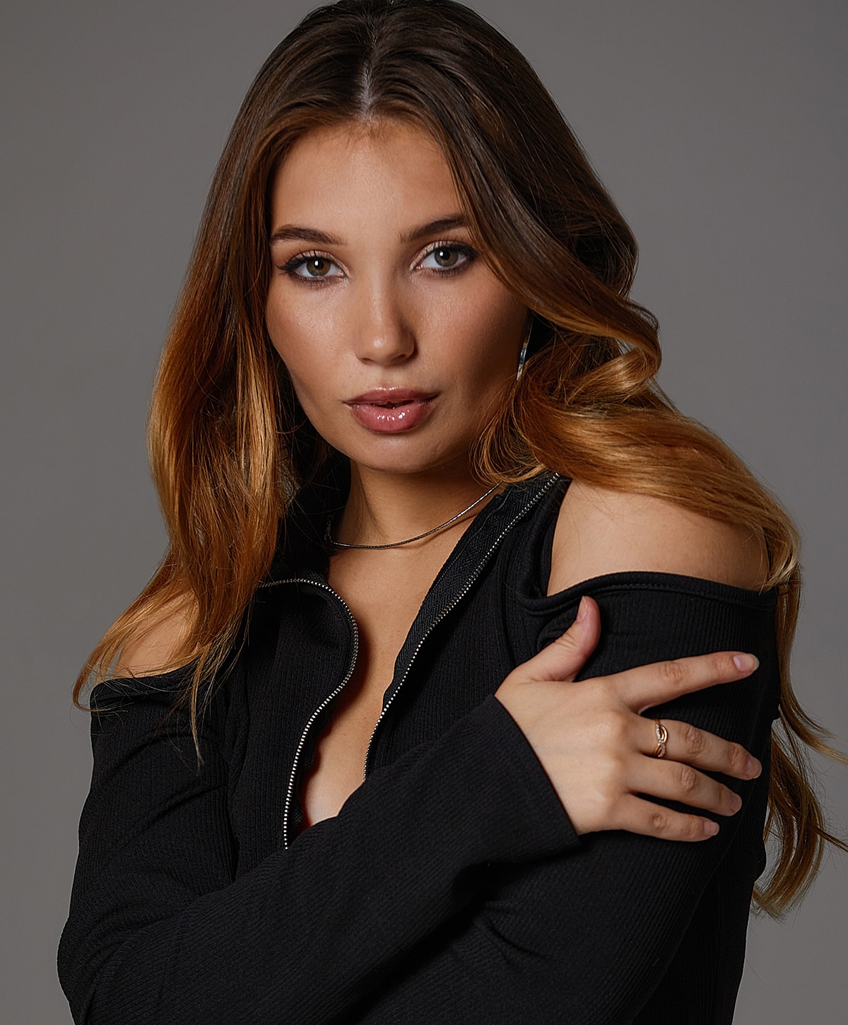 Model with long hair in a black outfit.