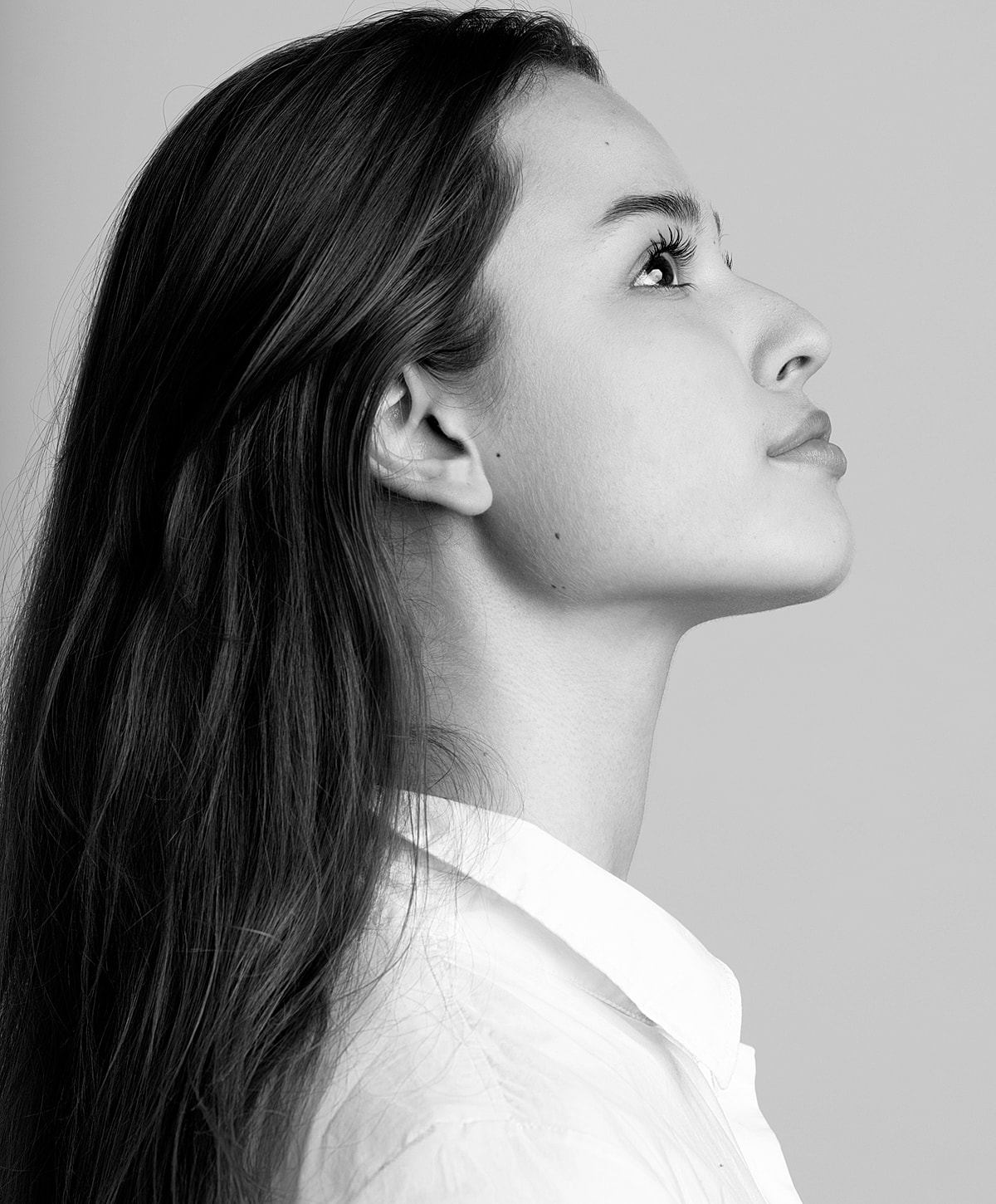Profile view of a woman with long hair.