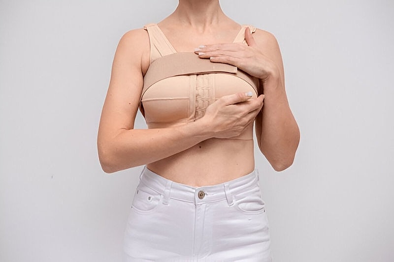 Model demonstrating supportive undergarment for women.