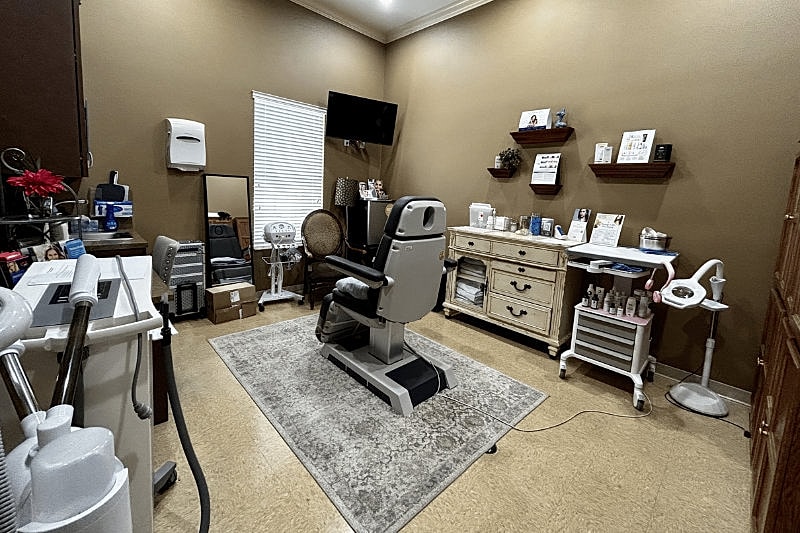 Cosmetology treatment room with equipment and furnishings.