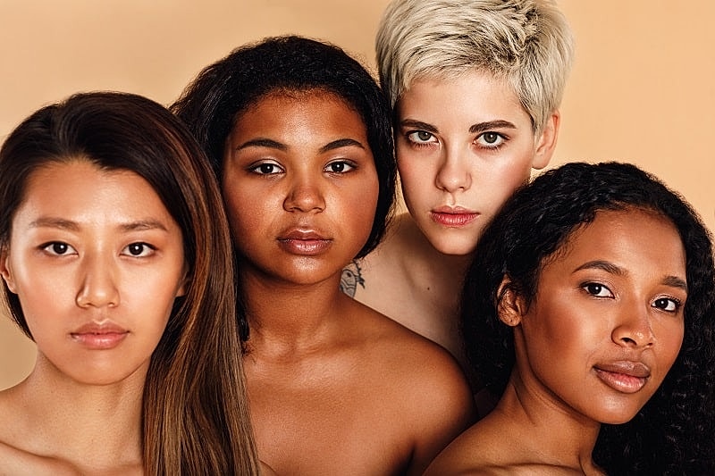 Diverse group of four women posing together.