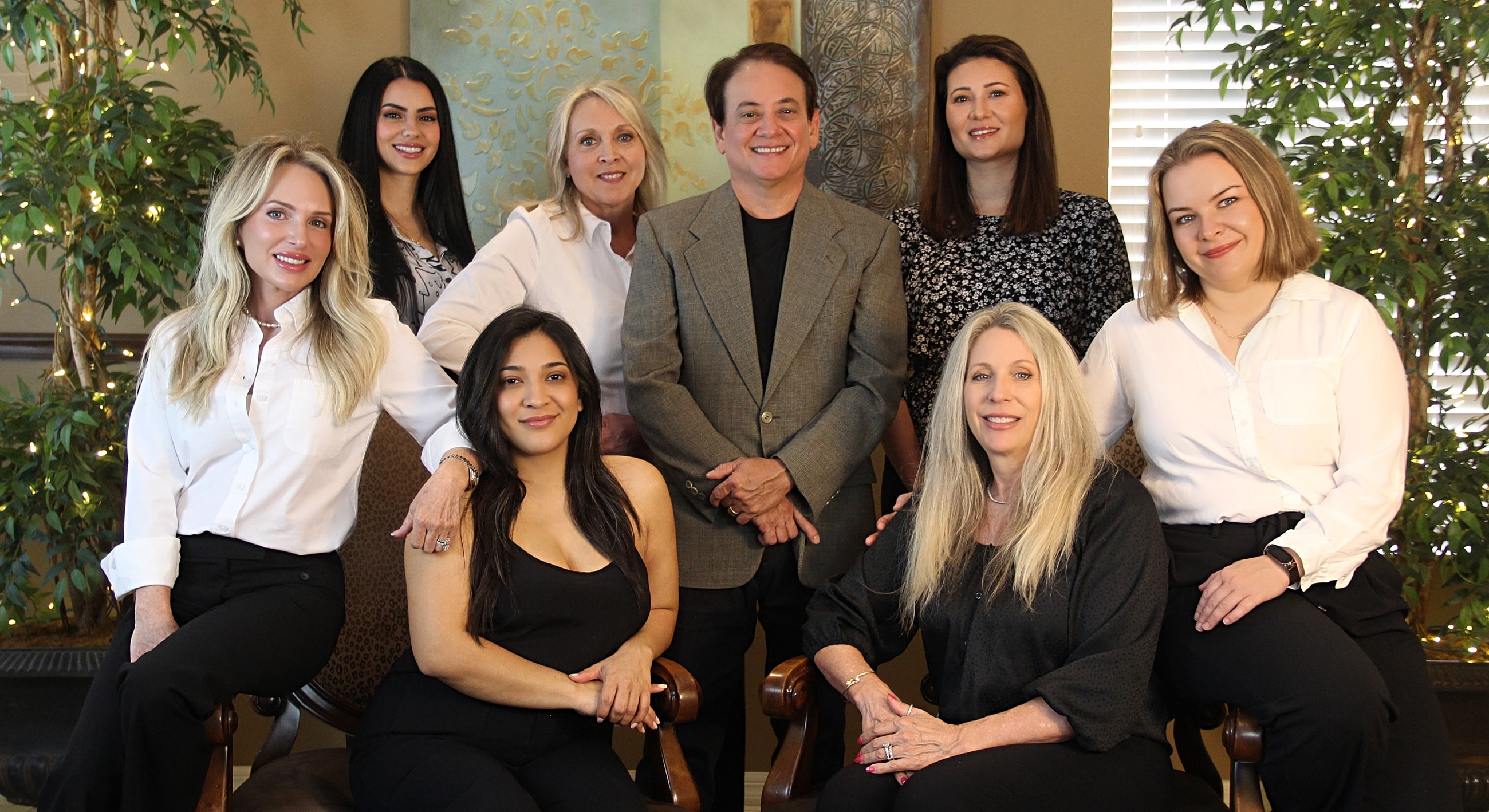 Professional group portrait of eight individuals.