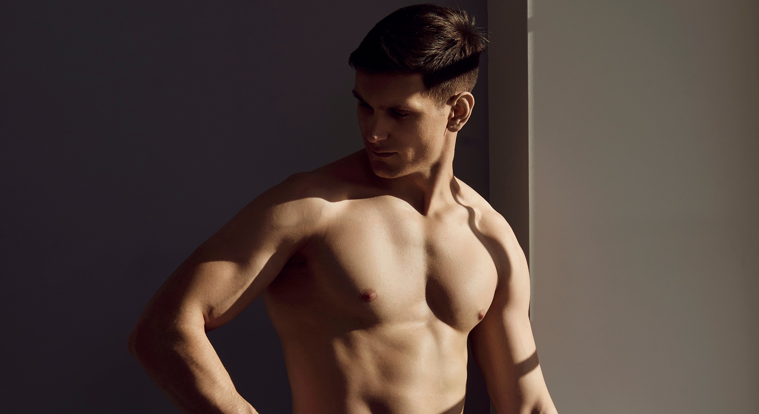 Male model posed in soft natural lighting.
