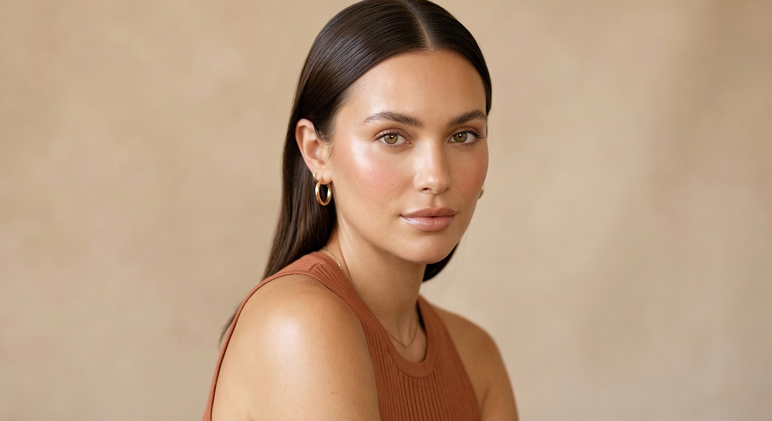 Woman with a natural makeup look and brown background.