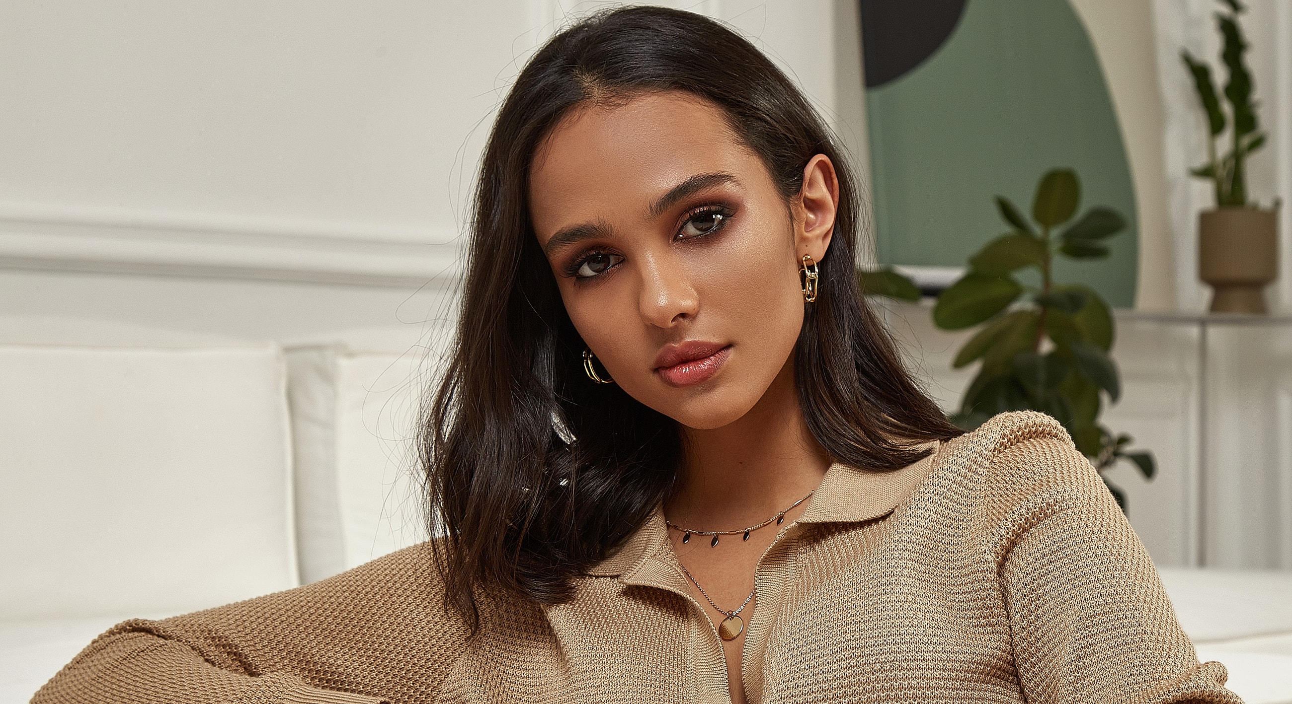 Woman with long hair wearing stylish jewelry.